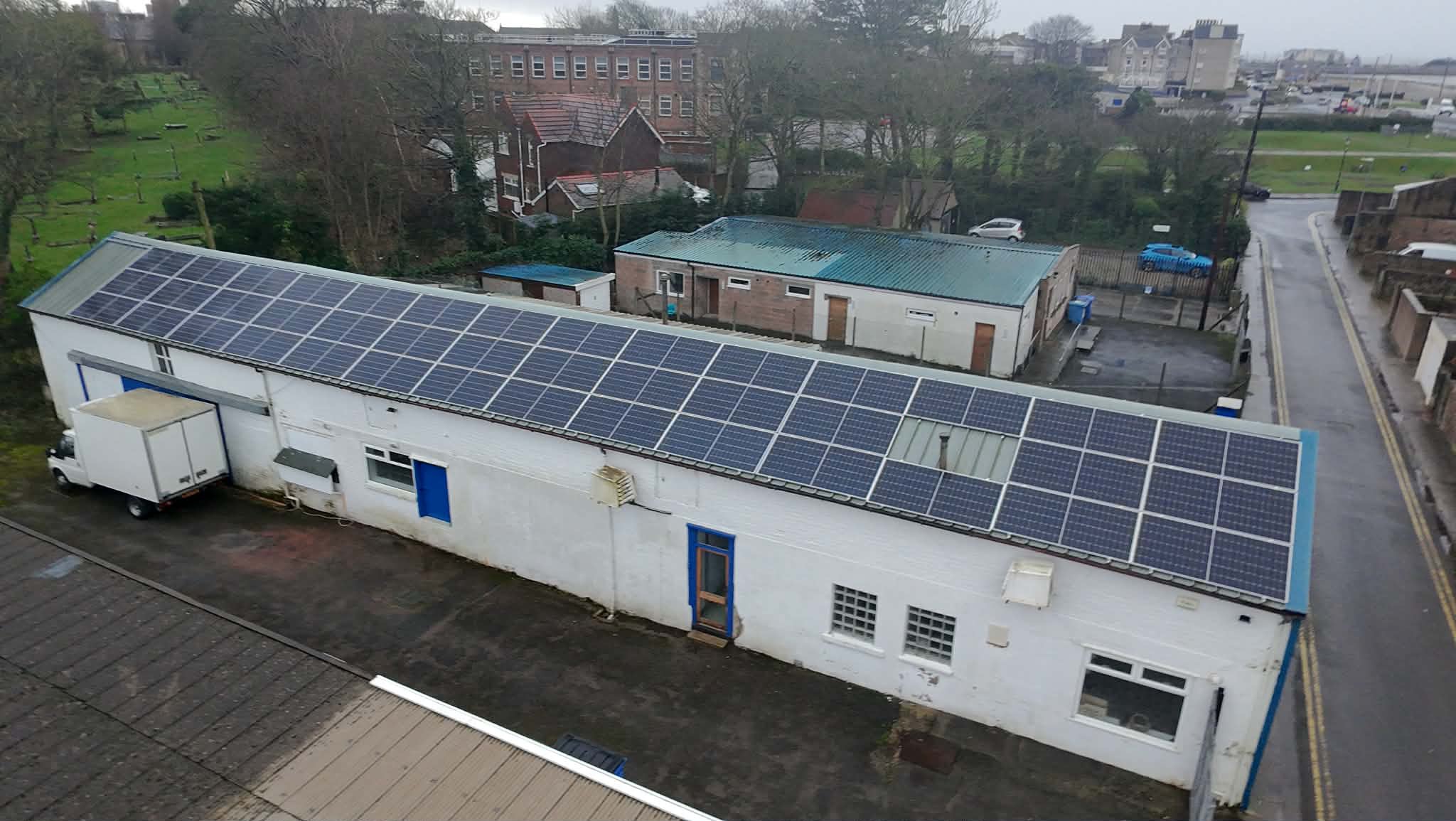 Commercial solar panel installation on industrial building